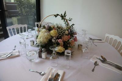 Miniature Location salle Noisy-le-Grand (Seine-Saint-Denis) - Espace du Mont d'Est #17 Centre de table floral avec roses et feuillage, entouré de tables dressées dans une salle lumineuse.