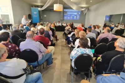 Des personnes se servent à un buffet dans un espace intérieur lumineux avec des boissons et des aliments disposés sur une…
