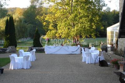 Miniature Location salle Rosay (Yvelines) - Manoir des Foulons #4 Salle décorée avec des ballons blancs et dorés, rangées de chaises rouges alignées sur un tapis rouge.