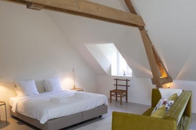 Deux colonnes en pierre encadrent un espace avec deux bureaux modernes, éclairés par des lampes murales.