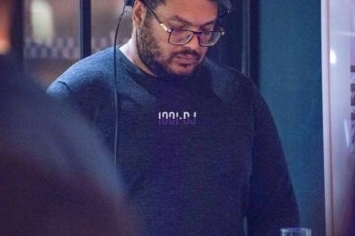 Miniature DJ Anse (Rhône) - Ikotorva Laurent #4 Un homme portant des écouteurs travaille sur un ordinateur portable dans un environnement faiblement éclairé.