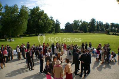 Groupe de personnes rassemblées dans un parc verdoyant lors d'un événement en plein air.