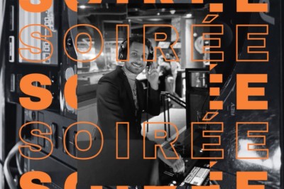 Miniature DJ La Queue-les-Yvelines (Yvelines) - DJ Braz #6 Main ajustant des réglages sur une table de mixage DJ lumineuse avec des écrans et des boutons colorés.