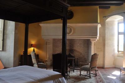 Miniature Location salle Bouesse (Indre) - Chateau de Bouesse en Berry #20 Vase de pivoines roses sur une table en bois, entouré de livres, chandeliers et fauteuils dans un salon élégant.