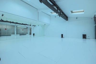 Miniature Location salle Paris 18 (Paris) - Loft Montmartre #10 Balcon étroit avec sol en bois, mur en pierre, grillage métallique et vue sur un jardin arboré.