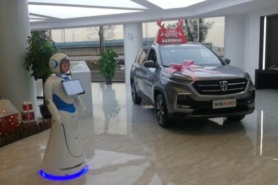 Robot humanoïde blanc équipé d'un écran et d'un plateau, présenté dans un environnement intérieur avec plantes et…