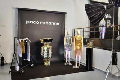 Intérieur d'un grand espace industriel lumineux avec sol clair, murs blancs, poutres métalliques et conduits apparents.