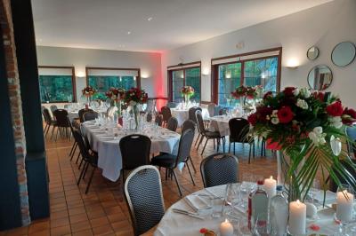 Miniature Location salle Mouscron (Hainaut) - Le Belvédère #16 Terrasse extérieure d'un restaurant avec des tables et chaises sur un sol en pierre, entourée de verdure et arbres.