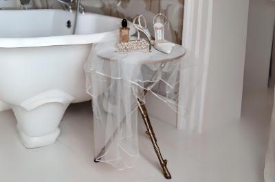 Miniature Votristoire #4 Table en bois longue dressée en extérieur, ornée de fleurs, citrons et vaisselle, entourée d'arbres et de verdure.