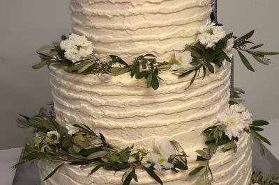 Miniature Location salle Noves (Bouches-du-Rhône) - Au Palais Gourmet - Dupas Traiteur #39 Gâteau de mariage à trois étages décoré de fleurs blanches, feuillages et roses crème au sommet.