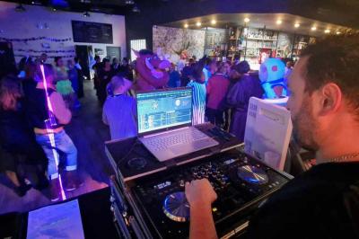 Table de mixage professionnelle avec plusieurs platines, écrans et commandes, sur fond bleu dégradé.