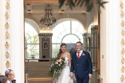 Un couple s'embrasse tendrement dans un cadre naturel entouré de branches d'olivier.