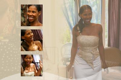 Femme souriante portant un blazer imprimé coloré, un t-shirt gris et un jean, posant devant un fond blanc.