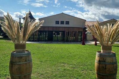 Table décorée avec des flûtes en verre, un bouquet de fleurs blanches, une bougie et des fauteuils ornés en arrière-plan.