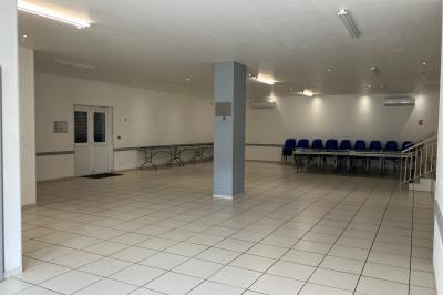 Miniature Salle de réception Plan d’un bâtiment avec disposition des pièces, entrées, parking et espaces extérieurs indiqués.