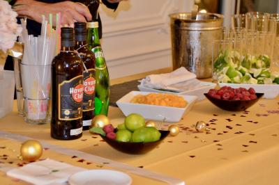 Miniature Traiteur Saint-Cloud (Hauts-de-Seine) - Aux Jardins des Sens #5 Façade illuminée d'un bâtiment élégant au crépuscule, avec un jardin et des invités rassemblés devant.