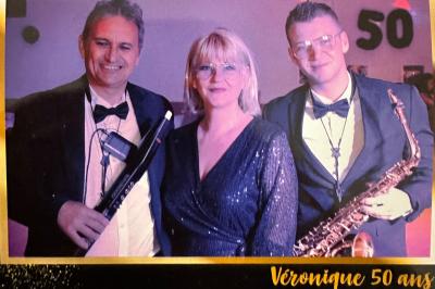 Miniature DJ Carcès (Var) - Dj Sax à Tout Coeur #17 Un homme en costume bleu tient un saxophone dans un intérieur lumineux avec de grandes fenêtres.