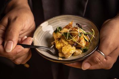 Miniature Location salle Paris 19 (Paris) - L'Envol de la Philharmonie #31 Un barman verse un liquide sombre dans un verre à cocktail rempli d'une boisson mousseuse.