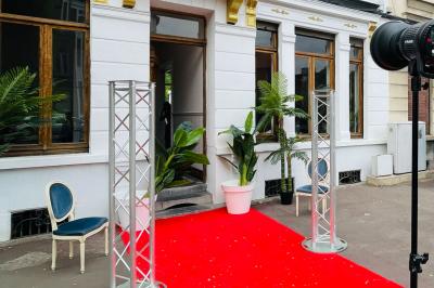 Salle de bain moderne avec lavabo double, miroir, toilettes grises et étagères décorées de plantes et flacons.