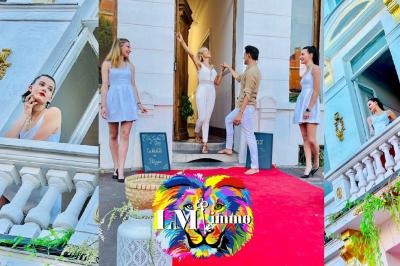 Salle de bain moderne avec lavabo double, miroir, toilettes grises et étagères décorées de plantes et flacons.