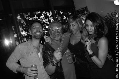 Miniature Location salle Paris 11 (Paris) - Bar de l'Hôtel de la Paix #5 Façade d'un café avec une table extérieure en bois, revêtement en gazon synthétique et intérieur éclairé visible.