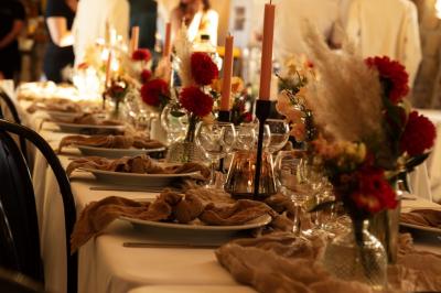 Miniature Location salle Esmery-Hallon (Somme) - La Bergerie #22 Salle de réception en pierre avec tables dressées, décorations florales et bougies, éclairée par la lumière naturelle.