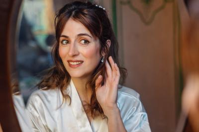 Un couple en tenue de mariage pose dans une forêt verdoyante, éclairée par une lumière douce.