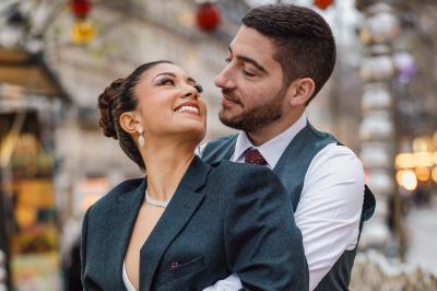 Un couple en tenue de mariage pose dans une forêt verdoyante, éclairée par une lumière douce.
