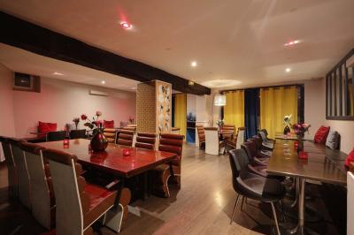 Miniature Location salle Rueil-Malmaison (Hauts-de-Seine) - La Casa #6 Salle de restaurant avec des tables dressées, des chaises en cuir marron et une enseigne murale ’LA CASA’.