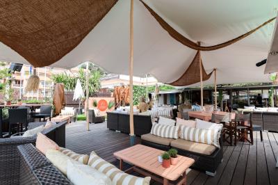 Miniature Location salle Mandelieu-la-Napoule (Alpes-Maritimes) - Restaurant le Repere #5 Rangées de chaises blanches alignées en extérieur, probablement pour un événement ou une cérémonie.