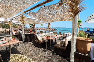 Miniature Location salle Mandelieu-la-Napoule (Alpes-Maritimes) - Restaurant le Repere #1 Rangées de chaises blanches alignées en extérieur, probablement pour un événement ou une cérémonie.