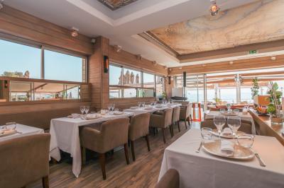 Miniature Location salle Mandelieu-la-Napoule (Alpes-Maritimes) - Restaurant le Repere #10 Rangées de chaises blanches alignées en extérieur, probablement pour un événement ou une cérémonie.