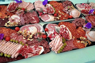 Borne photo interactive éclairée entourée de poteaux dorés et cordons rouges sur un tapis rouge dans une salle lumineuse.