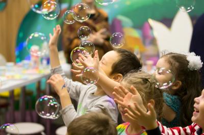 Miniature Event&co Art'gency #9 Un homme déguisé en Père Noël lit une lettre avec deux enfants souriants dans un décor chaleureux.