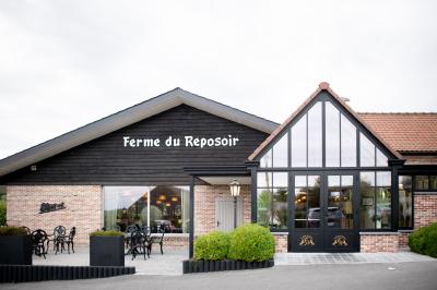 Miniature Location salle Tournai (Hainaut) - La Ferme du Reposoir #2 Un groupe de daims tachetés marche sur une pelouse verte devant une haie dense.