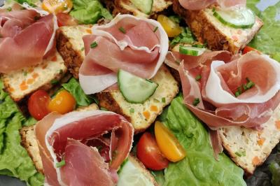 Table dressée avec des verres et un seau à champagne devant une baie vitrée, logo ’Aux Saveurs du Jour’ au mur.