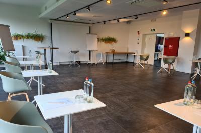 Exposition de véhicules Range Rover et Jaguar dans un showroom éclairé avec des fiches techniques visibles.