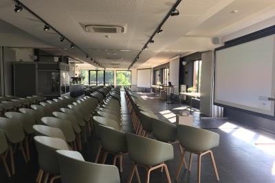 Exposition de véhicules Range Rover et Jaguar dans un showroom éclairé avec des fiches techniques visibles.