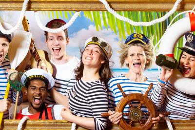 Miniature Studio le Carré #3 Femme portant des lunettes en forme de cœur jouant de la guitare électrique dans un décor rétro avec objets dorés.