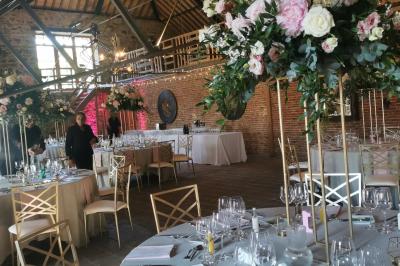 Miniature Salle Hermès Un couple en tenue de mariage se tient devant un officiant dans un décor festif avec sapins et guirlandes lumineuses.