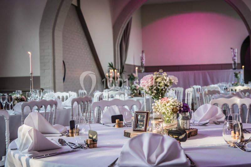 Location salle Comines (Nord) - Les Salons du Château - France Evénement #9 Salle de réception décorée avec des tables élégantes, nappes blanches, bougies et arrangements floraux.
