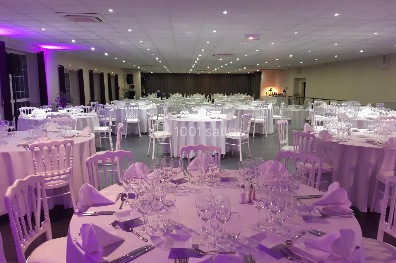 Location salle Comines (Nord) - Les Salons du Château - France Evénement #8 Salle de réception décorée avec des tables rondes dressées de nappes blanches, verres et couverts.