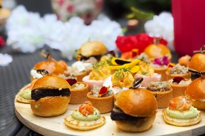 Miniature Traiteur Lyon 2 (Rhône) - Food And Beyond #21 Sandwiches colorés empilés avec des garnitures variées, entourés de roquette et d'olives vertes.