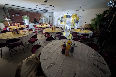 Miniature Location salle Seclin (Nord) - Luminaria #77 Décor festif avec ballons noirs, dorés, argentés et blancs, fond scintillant et deux tabourets blancs devant.