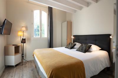 Miniature Location salle Sommières (Gard) - Domaine de l’Estelou #19 Grande table dressée en extérieur avec des chaises en bois, sous une pergola illuminée de lumières violettes, devant un…