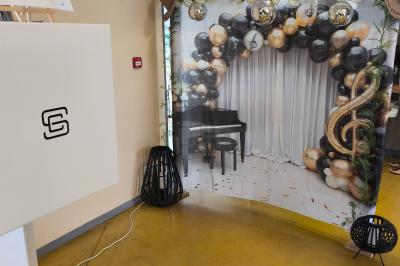 Miniature Anniversaire thème Musique et Danse Des personnes dansent et discutent dans une salle éclairée par des lumières colorées lors d'un événement festif.