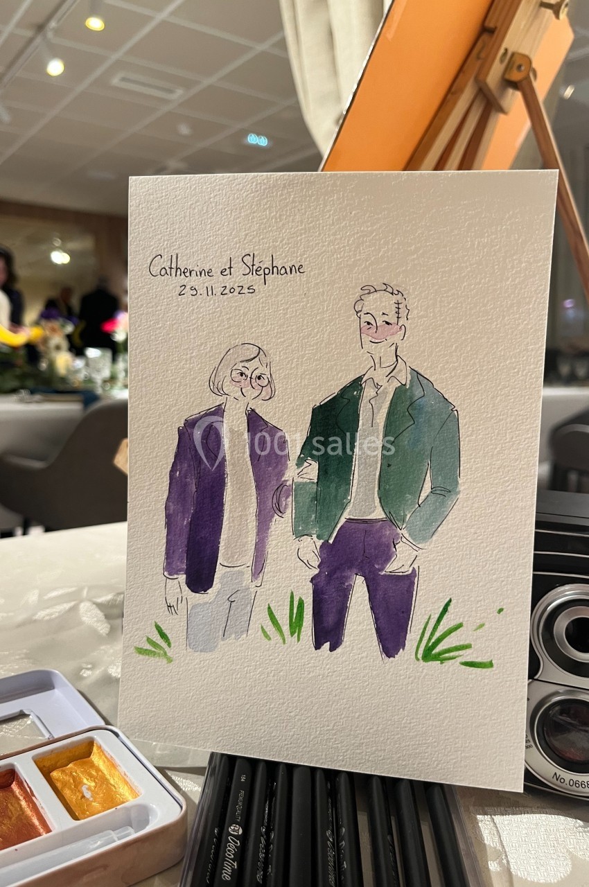 Illustration d'un couple debout, réalisée à l'aquarelle, posée sur une table avec des fournitures artistiques.