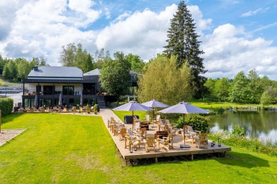 Rangée de vélos électriques noirs et rouges alignés dans un entrepôt avec des supports de rangement en arrière-plan.