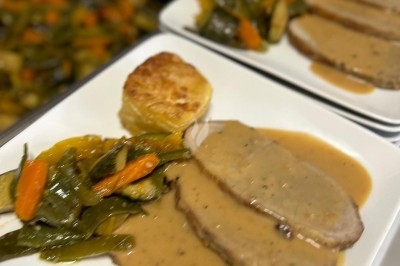 Miniature Traiteur Crosne (Essonne) - Aux Tulipes Traiteur #6 Assiette de burrata garnie de tomates cerises colorées et décorée d'une fleur violette sur une table blanche.