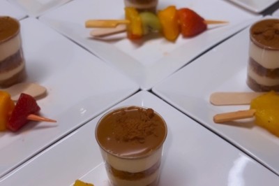 Miniature Traiteur Paris 8 (Paris) - Les Trois Soeurs Traiteur #5 Table de réception élégamment dressée avec chandeliers, fleurs pourpres et vaisselle raffinée dans une salle lumineuse.